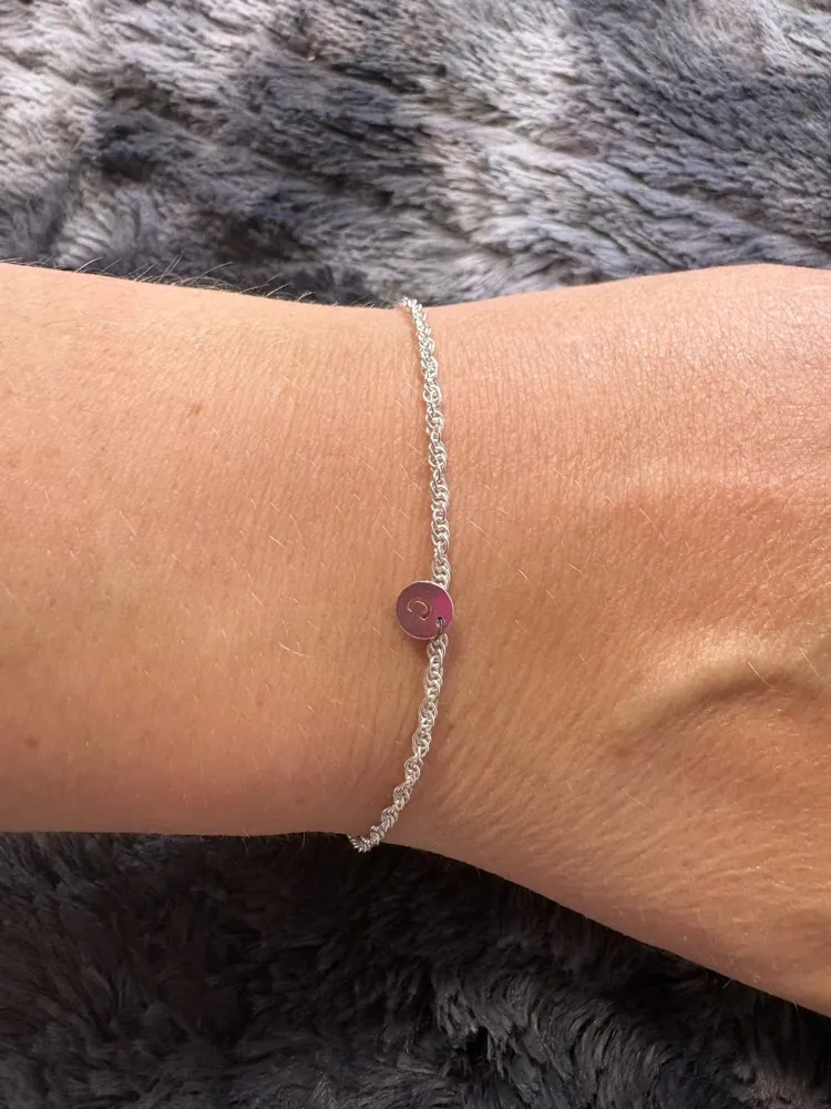 Welded permanent bracelet with a charm